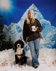 Woman wearing an 8.6.4 cashmere beanie in light purple with a dog on a colorful rope leash in front of a graphic mountainous backdrop
