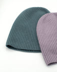 Two cashmere beanies in Light Purple and Norfolk Blue.