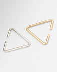 Close up of 8.6.4 handmade triangle ear cuff in brass and silver.