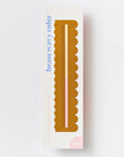 Another Studio brass wavy ruler in its cream packaging with blue lettering