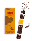 Antidote Mango and Juniper 73% dark chocolate bar in orange wrapping beside chocolate pieces