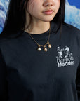 Woman wearing vintage shell cameo necklace with gold floral accents on a black, graphic tshirt