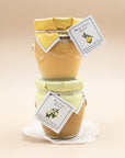 Stacked jars of Bella Cucina Meyer Lemon and Key Lime spreads with fabric lids and tags