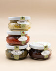 Four 3 oz Bella Cucina pesto jars: basil, artichoke lemon, sweet pepper and sun-dried tomato