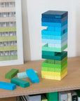 Gradient Tower mid-game with blocks pulled out, loose blue and green blocks nearby