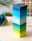Block Design Gradient Tower of wooden blocks shading from navy to yellow on a table