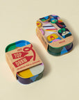 Block Design Top Draw drawing pad and crayons tin in its kraft sleeve, stacked on another tin