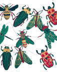 Hand-printed paper beetles, bees, moths and a dragonfly from the garland, laid out on white