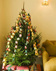 Christmas tree wrapped in red, green and gold patterned paper chains