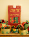 East End Press Paper Chains kit in its red packet with patterned paper chain loops