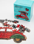 Half-finished red car Jiggies mini puzzle in front of its teal box