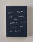 Navy Poète notebook with a handwritten cover quote about progress taking time