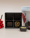 MECHA Tea Box ganaches open beside a coffee cup, with one chocolate cut to show its green filling