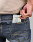 Pocket Aid Kit tin tucked into the back pocket of someone's jeans