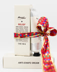 Tube and box of Mayron's Goods Anti-chafe cream with a colorful bow on a white background