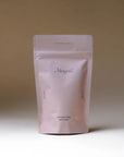 Merigold Coconut Rose bath salts in a matte blush pink pouch