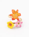 A hand-painted porcelain floral and gold ring on a white background