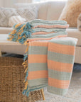Stack of colorful striped Turkish towels on a coffee table with a blurred background