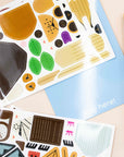 Reusable vinyl sticker sheets of Charley Harper animal shapes on a pale blue playboard