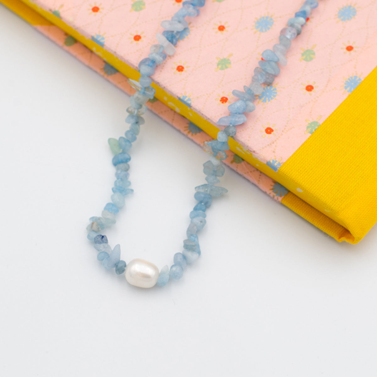 blue resin puka necklace with pearl