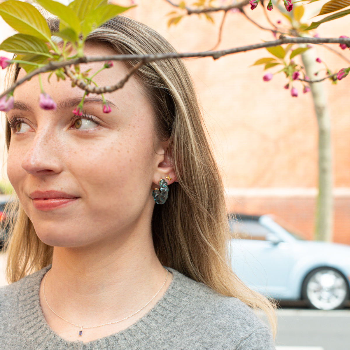 girl wearing The Shorebreak blue resin hoop earrings
