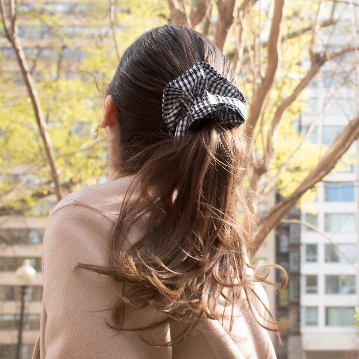 girl wearing a gingham ruffle scrunchie