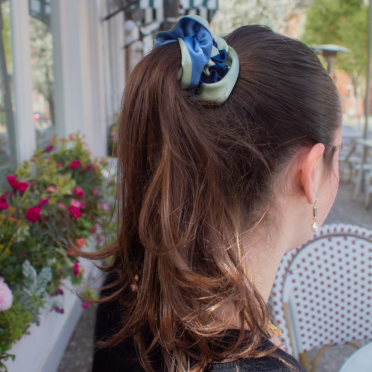 girl wearing reversible ruffle ribbon scrunchie in seafoam green and baby blue