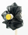 Oversized, black organza scrunchie on a peg.