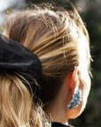 Close up of oversized, black organza scrunchie on a woman with a blonde ponytail