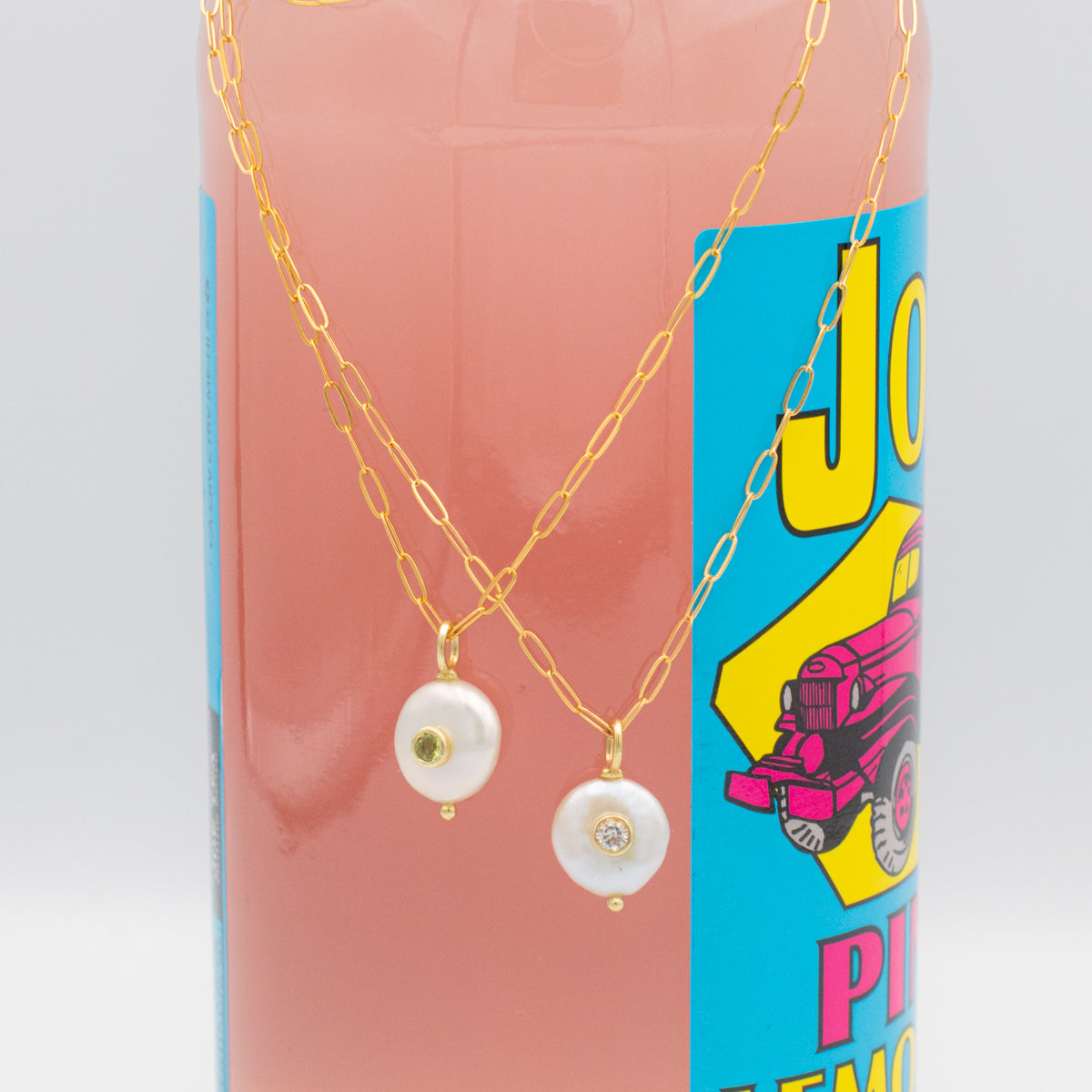 Pearl with set-in peridot or white topaz gemstone on a gold paperclip chain necklace
