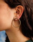 Close up of woman's profile wearing Sailors Valentine brass Rope Hoop earring