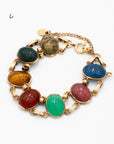 Vintage scarab bracelet with seven carved gemstones: onyx, agate, green agate, blue lace agate, rhodonite, tiger's eye, unakite linked in gold-filled double setting