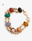 Vintage scarab bracelet with seven carved gemstone including: tiger's eye, blue chalcedony, green chalcedony, moss agate, carnelian, rhodonite, rhyolite connected via gold-filled double link setting