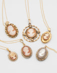 Collection of vintage gold-filled necklaces with cameo pendants on a white background