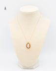 Hand-carved shell cameo, in an intricate, braided, gold-filled setting on an 18" chain