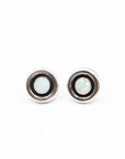 Pair of round vintage opal earring studs with black and silver rims on a white background
