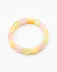 Single rainbow agate beaded stone bracelet in soft pink, yellow, and green hues photographed flat against a white background.