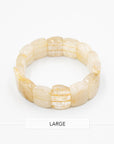 Rutile quartz beaded stone bracelet displayed flat against a white background, showcasing its golden hair-like inclusions.