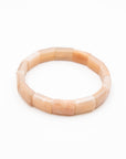 Single sunstone beaded stone bracelet with tumbled peach-toned beads photographed flat against a white background.