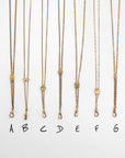 Six gold-filled Victorian-era chatelaine slider necklaces with different pendant styles are displayed vertically on a white background, labeled A through G below.