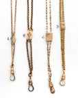 Up close shot of four antique grand deco chatelaine slider necklaces with turquoise and pearl seed stones