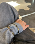 Vintage onyx gold-filled bracelet worn with a gray sweater