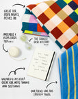 A styled flat-lay of a colorful patchwork knit blanket and a blue striped knit towel on a white background, with handwritten callouts and arrows describing uses such as movie nights, picnics, desk accessory, note-taking, and stretching.