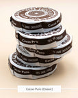 Stack of Taza Cacao Puro 70% dark chocolate discs in their paper wrappers