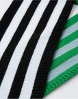 Close-up of the mini ribbon scarf's black, white and green stripes and ribbed edge