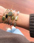 Woman wearing vintage onyx bracelet made from reclaimed watch band — elegant small-business jewelry gift.
