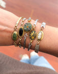 Woman wearing vintage onyx bracelet made from reclaimed watch band — elegant small-business jewelry gift.