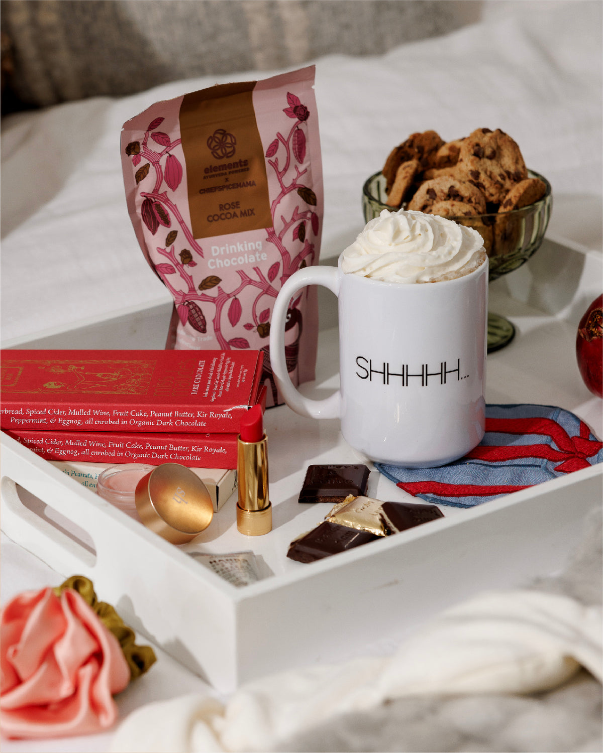 Elements rose hot chocolate mix on a breakfast tray with a whipped cream mug and cookies