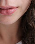 Close-up of a person's lips using Abature's lip kit. 
