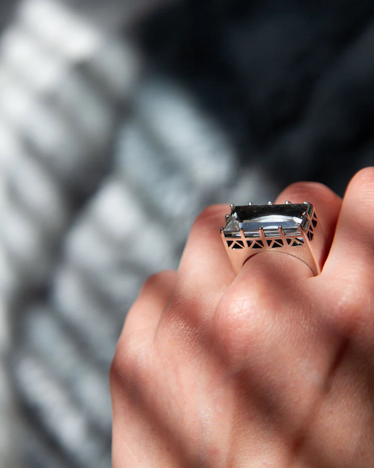 Close-up of a hand wearing the East/West quartz statement ring in solid sterling silver.